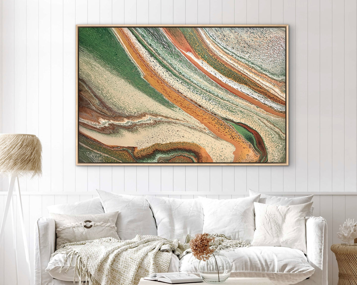 Sculpted Plains large green and terracotta abstract landscape painting styled above a white sofa
