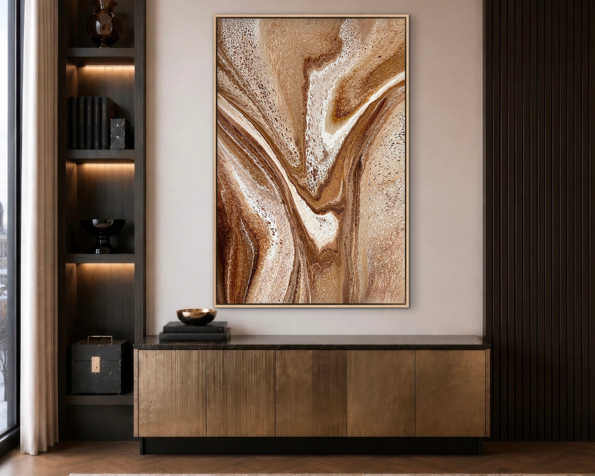 Restless Terrain warm brown abstract painting displayed vertically above a timber sideboard in a dark modern interior

