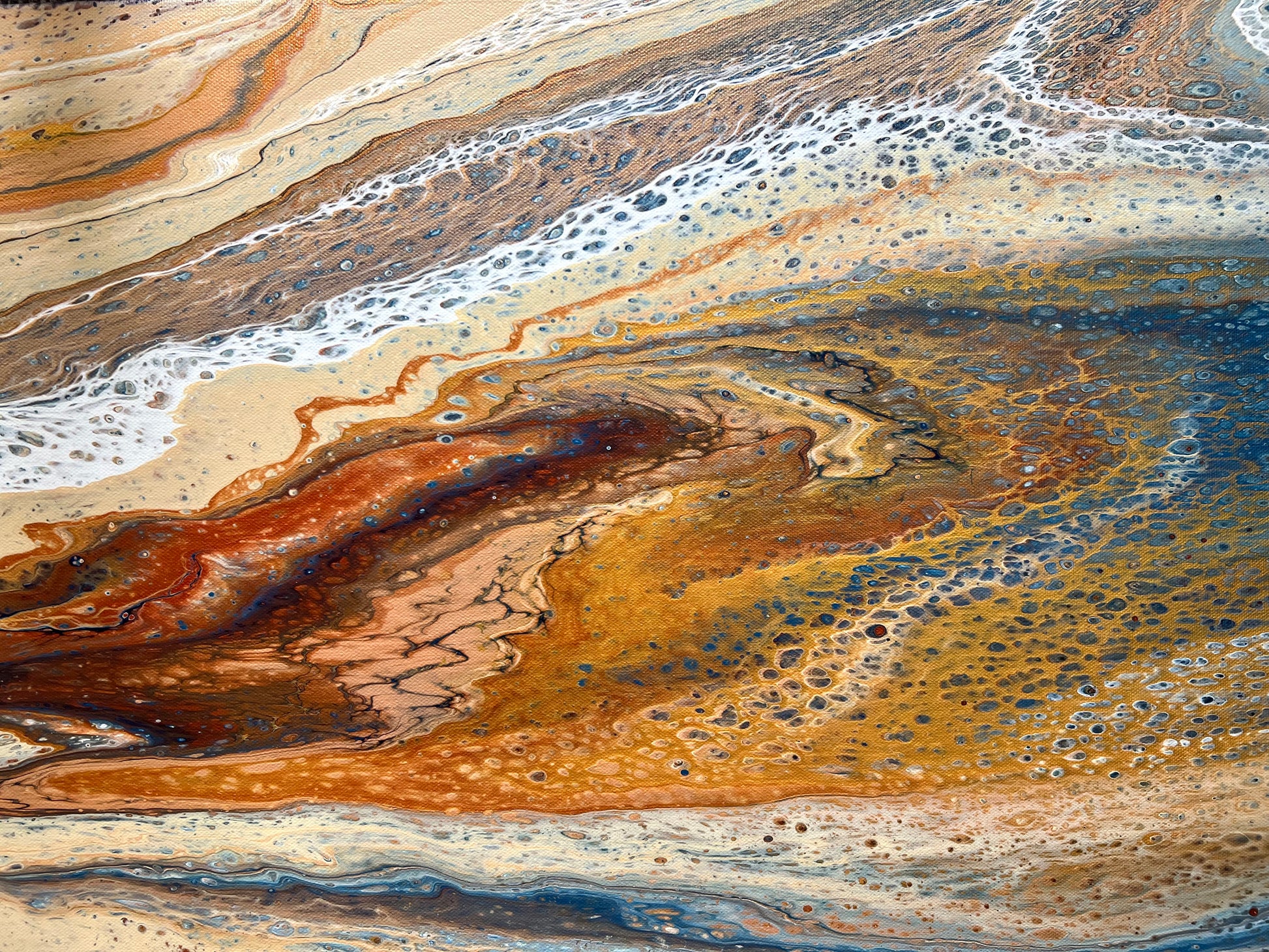Close-up of Desert Drift original fluid acrylic painting showing golden ochre, rust and deep blue, intricate cells and sweeping colour transitions