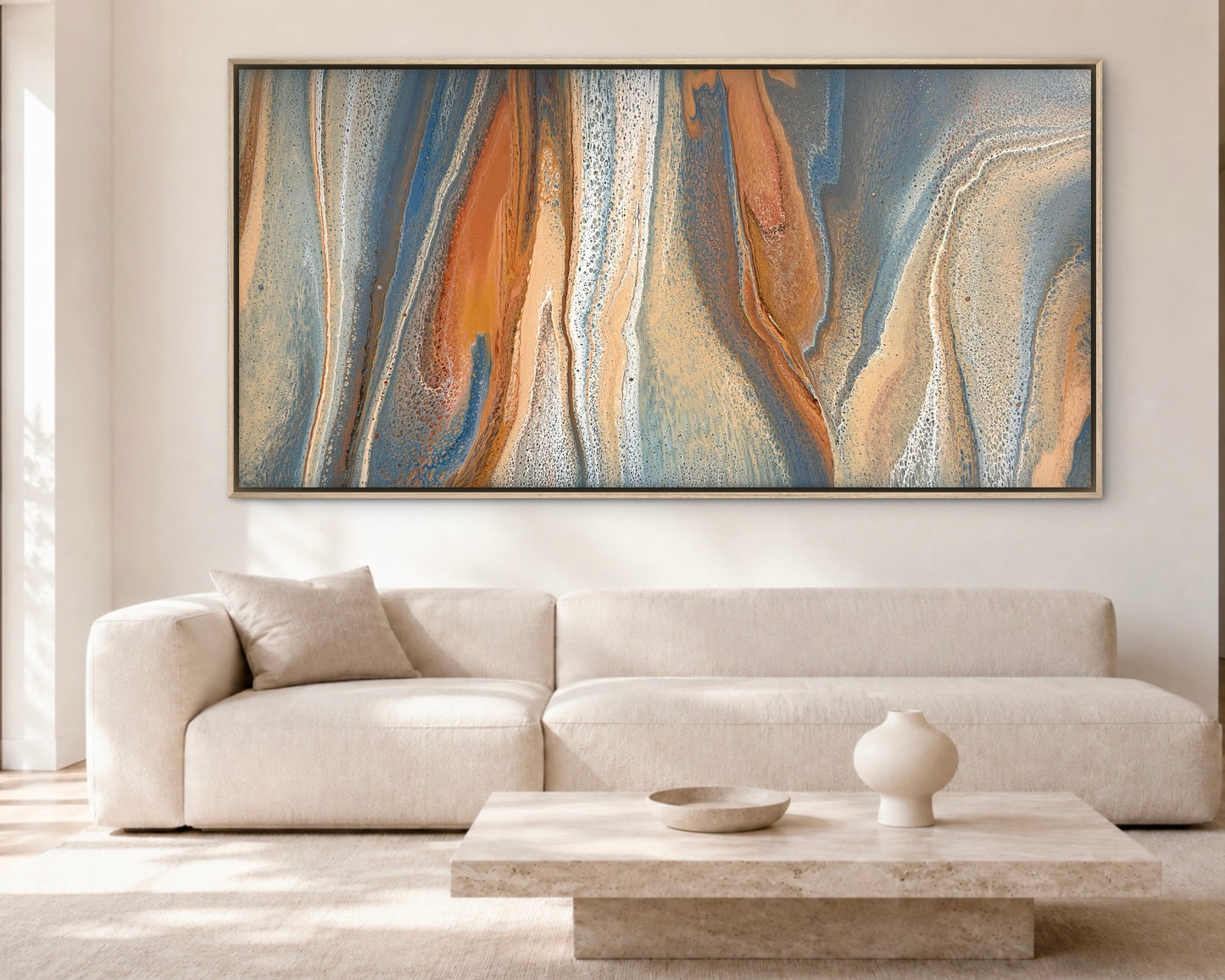 Exposed Shores oversized original abstract painting in coastal blue, copper, sand and cream, displayed above a white sofa in a contemporary living room