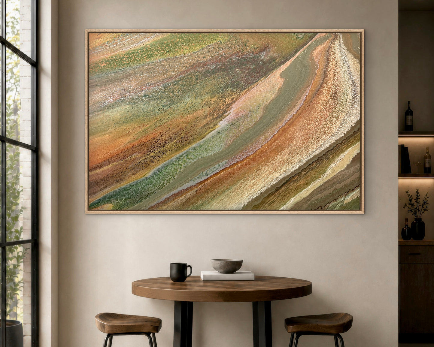 Grounded Light original green and gold abstract painting displayed above a café table in a contemporary restaurant and hospitality interior