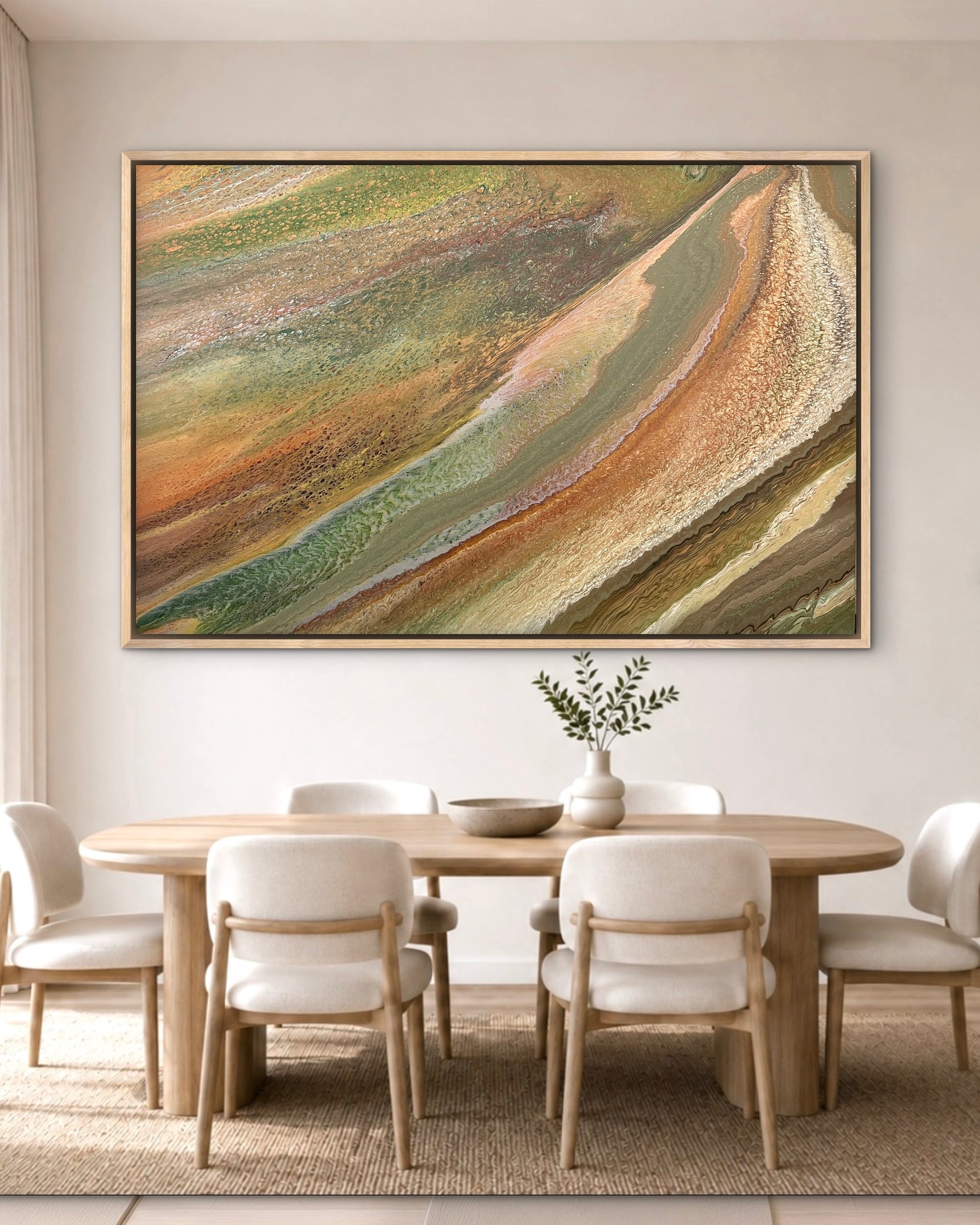 Grounded Light large green and gold abstract artwork displayed in an oak frame above a round timber table in a bright organic-modern dining room
