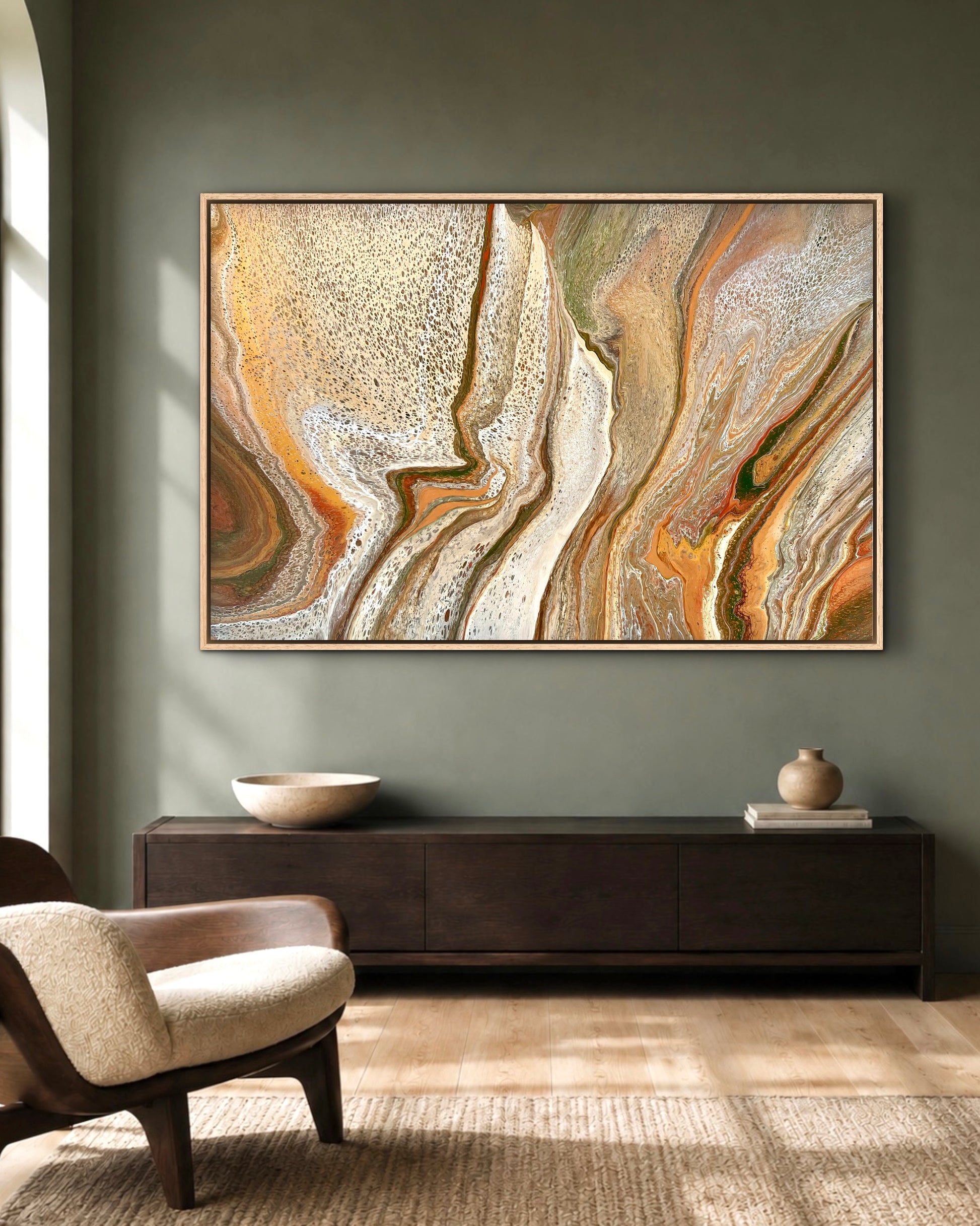 Mineral Divide original earth-tone artwork in cream, bronze and olive, displayed above a dark timber console against a deep green wall