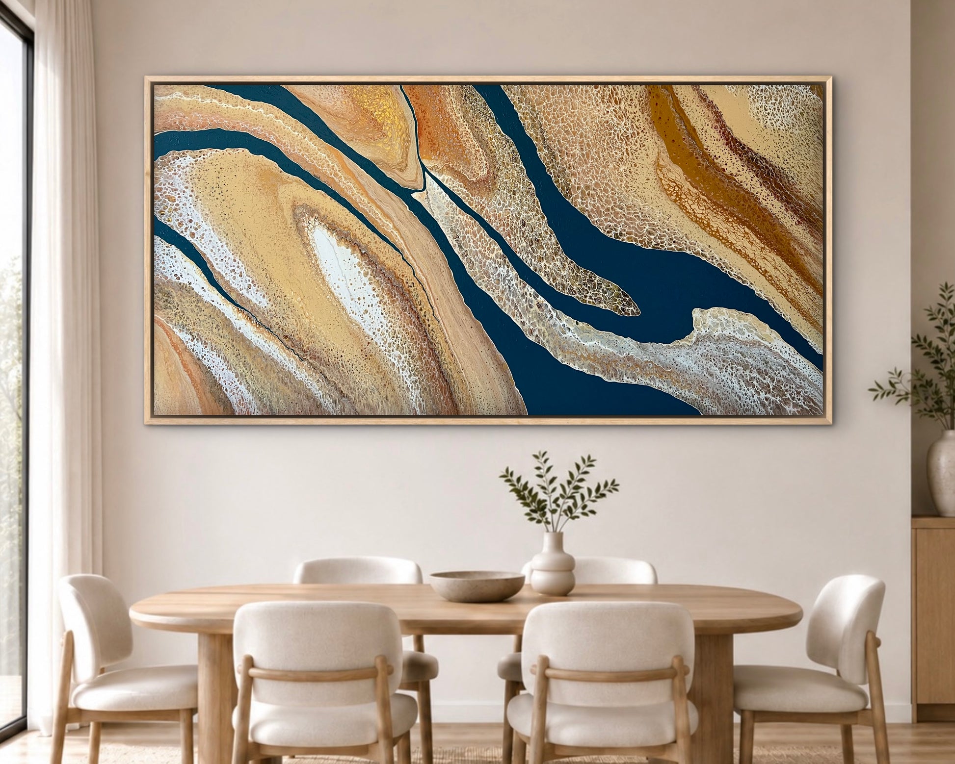 Rivers Divide extra-large original textured abstract painting in deep navy, gold and cream displayed above a round timber table in a bright contemporary dining room